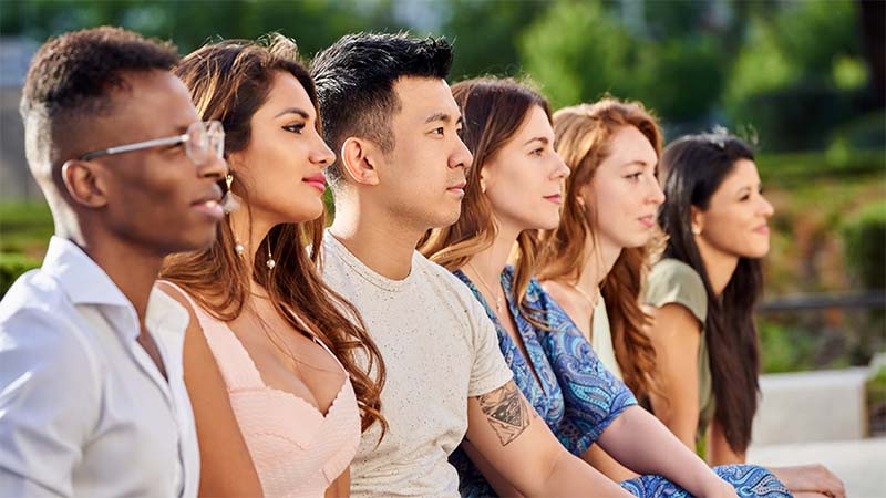 Group Of Multiracial People Looking Away While Sitting Together