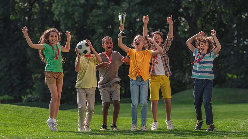 Kids Celebrating On Soccer Field