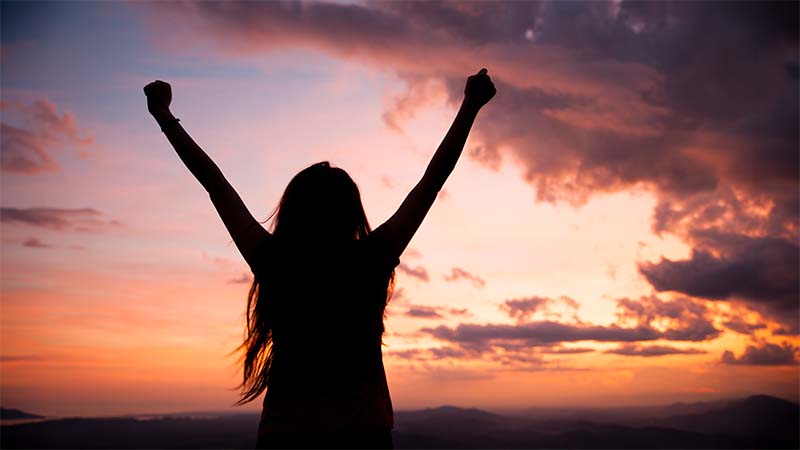 Woman Silhouette In Evening Raising Arms